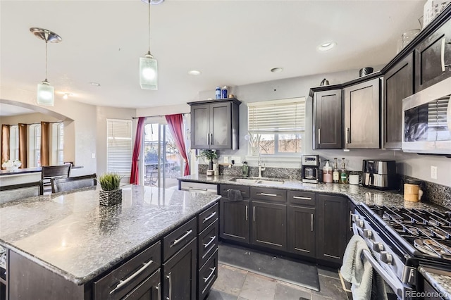 9990 Jasper St, Commerce City, CO 80022 - kitchen featuring a sink, stainless steel appliances, light stone counters, decorative light fixtures, and recessed lighting