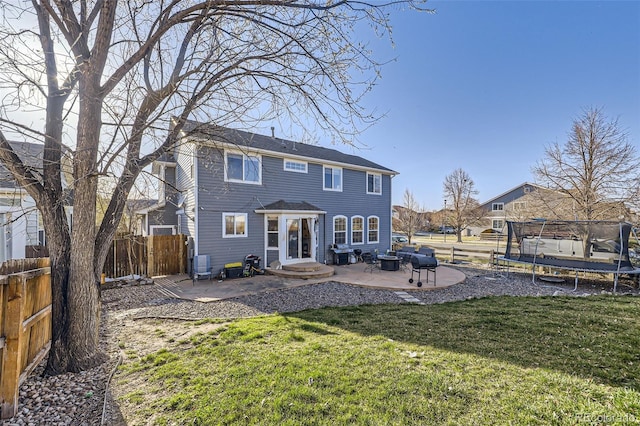 9990 Jasper St, Commerce City, CO 80022 - rear view of property featuring a trampoline, a patio, and entry steps