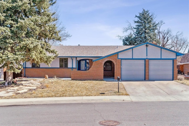 ranch-style house with an attached garage, driveway, a shingled roof, and brick siding