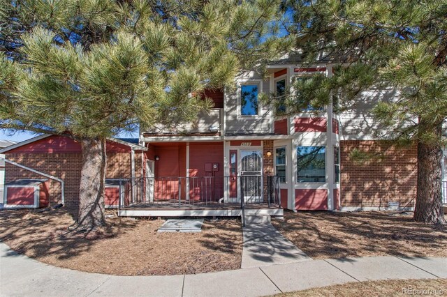 432 W Rockrimmon Blvd Unit B, Colorado Springs, CO 80919 - view of front of home with brick siding and a porch