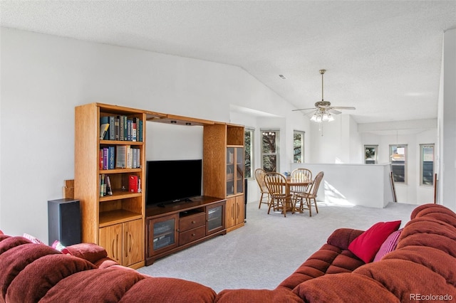 432 W Rockrimmon Blvd Unit B, Colorado Springs, CO 80919 - carpeted living area with vaulted ceiling, a textured ceiling, and a ceiling fan