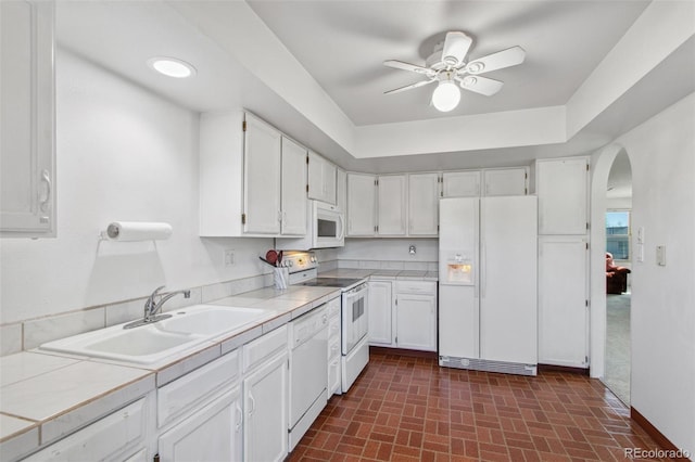 432 W Rockrimmon Blvd Unit B, Colorado Springs, CO 80919 - kitchen with white appliances, tile countertops, white cabinets, and arched walkways