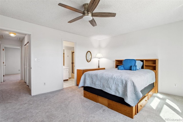 432 W Rockrimmon Blvd Unit B, Colorado Springs, CO 80919 - carpeted bedroom with a textured ceiling, attic access, ensuite bath, and ceiling fan