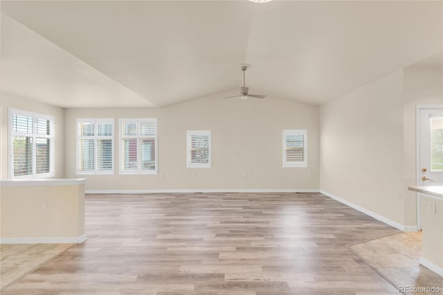 unfurnished living room with light hardwood / wood-style floors, vaulted ceiling, and ceiling fan