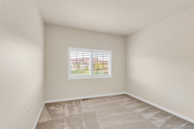 spare room with light colored carpet