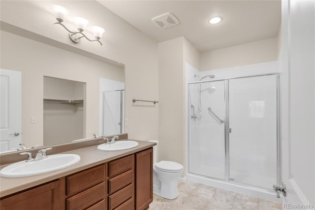 bathroom with toilet, an enclosed shower, and vanity