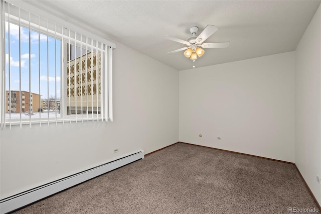 unfurnished room featuring a baseboard radiator, carpet floors, and ceiling fan