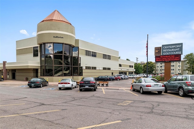 view of building exterior featuring uncovered parking