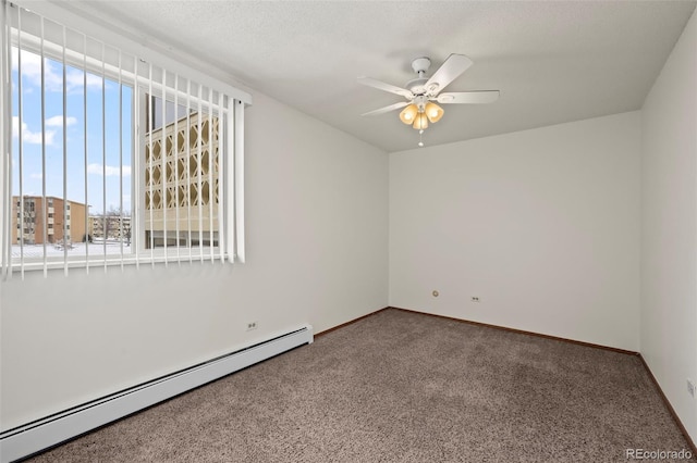 9300 E Center Ave Unit 2B, Denver, CO 80247 - carpeted spare room featuring a baseboard radiator, healthy amount of natural light, ceiling fan, and baseboards