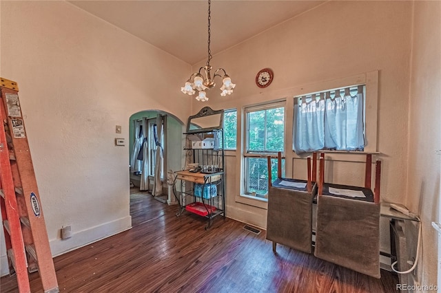 939 Conejos St, Colorado Springs, CO 80903 - dining room with arched walkways, wood finished floors, a high ceiling, and a chandelier