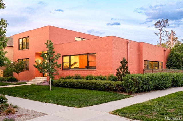 1188 S Sherman St, Denver, CO 80210 - view of front facade with brick siding and a front lawn