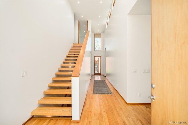1188 S Sherman St, Denver, CO 80210 - stairway featuring wood finished floors, a towering ceiling, baseboards, and recessed lighting