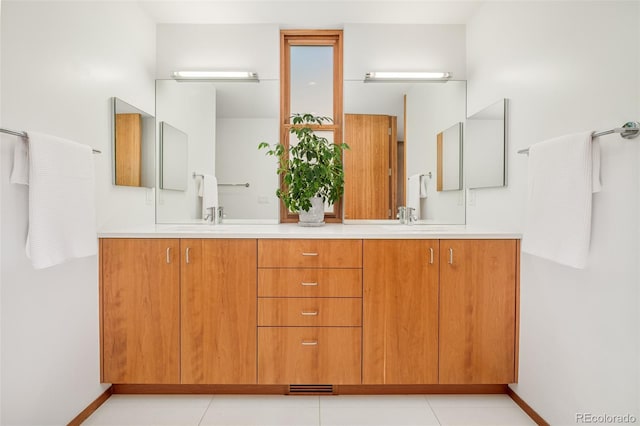1188 S Sherman St, Denver, CO 80210 - bathroom with double vanity, tile patterned flooring, and baseboards