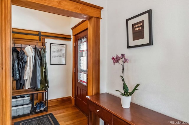 mudroom featuring wood finished floors and baseboards