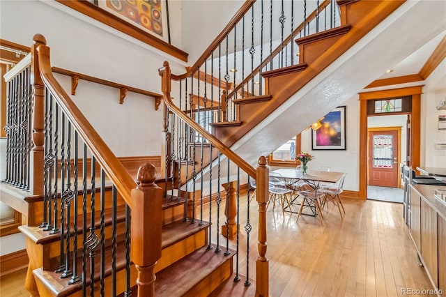 staircase with wood-type flooring and baseboards