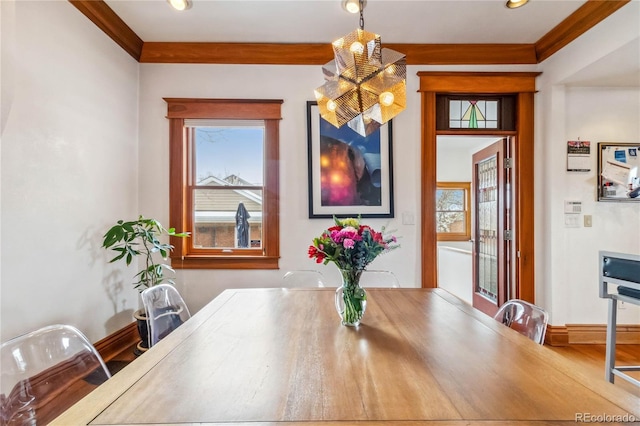 dining space with ornamental molding and baseboards