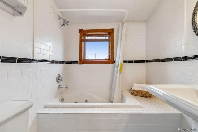 full bath with tile walls, toilet, and a combined bath / shower with jetted tub
