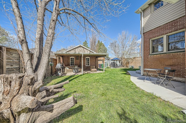 view of yard featuring a patio area and an outbuilding