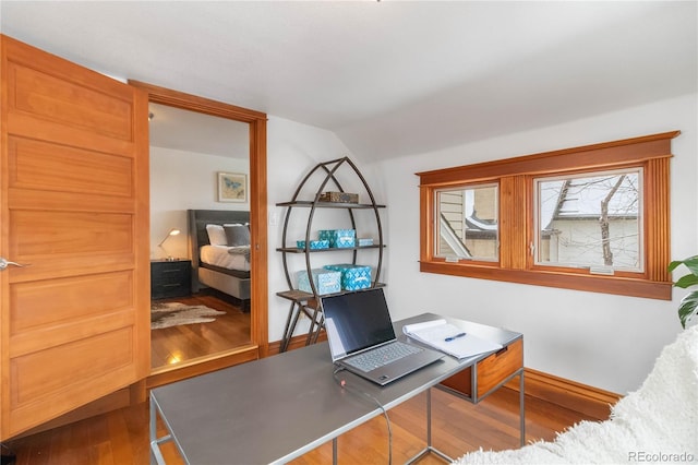 home office with wood finished floors and lofted ceiling