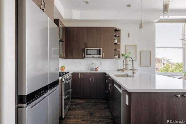 1932 W 32nd Ave, Denver, CO 80211 - kitchen featuring stainless steel appliances, open shelves, dark wood-type flooring, dark brown cabinetry, and light countertops