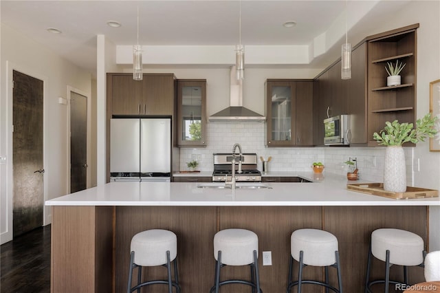 1932 W 32nd Ave, Denver, CO 80211 - kitchen featuring appliances with stainless steel finishes, wall chimney exhaust hood, open shelves, light countertops, and tasteful backsplash