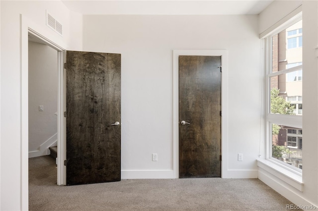 1932 W 32nd Ave, Denver, CO 80211 - unfurnished bedroom featuring carpet flooring and multiple windows