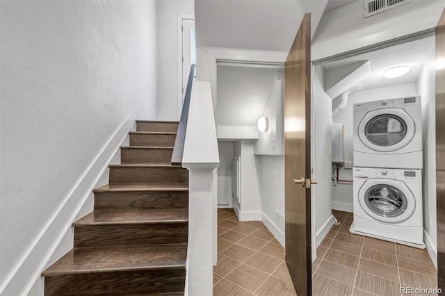 1932 W 32nd Ave, Denver, CO 80211 - washroom featuring stacked washing machine and dryer and baseboards