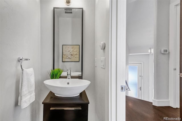 1932 W 32nd Ave, Denver, CO 80211 - bathroom with vanity and wood finished floors