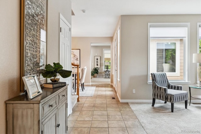 2601 Pemberly Ave, Highlands Ranch, CO 80126 - hall with light tile patterned floors, baseboards, and light colored carpet