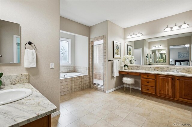 2601 Pemberly Ave, Highlands Ranch, CO 80126 - full bathroom with two vanities, a bath, a stall shower, and tile patterned flooring