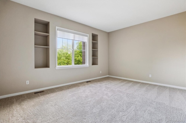 2601 Pemberly Ave, Highlands Ranch, CO 80126 - unfurnished room featuring baseboards, carpet, and built in shelves