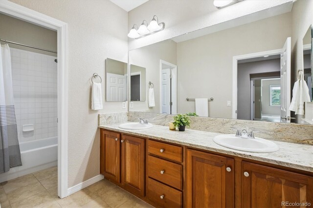 2601 Pemberly Ave, Highlands Ranch, CO 80126 - bathroom featuring double vanity, tile patterned floors, shower / bath combination with curtain, and baseboards