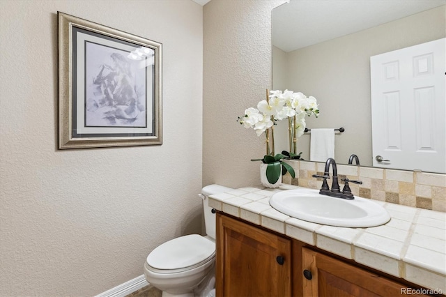 2601 Pemberly Ave, Highlands Ranch, CO 80126 - half bath with vanity, a textured wall, and toilet