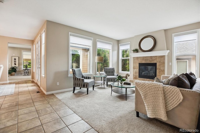 2601 Pemberly Ave, Highlands Ranch, CO 80126 - living area featuring light carpet, a fireplace, baseboards, and light tile patterned flooring