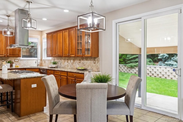 2601 Pemberly Ave, Highlands Ranch, CO 80126 - kitchen with ventilation hood, brown cabinetry, a sink, a chandelier, and recessed lighting