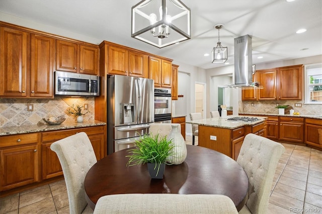 2601 Pemberly Ave, Highlands Ranch, CO 80126 - kitchen with stainless steel appliances, island range hood, brown cabinets, tasteful backsplash, and recessed lighting