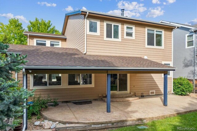2601 Pemberly Ave, Highlands Ranch, CO 80126 - rear view of house featuring a patio, a shingled roof, and entry steps