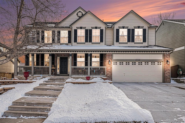 view of front of property featuring a garage and a porch