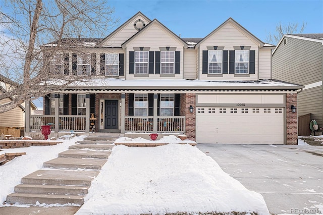 view of front of property with a porch and a garage