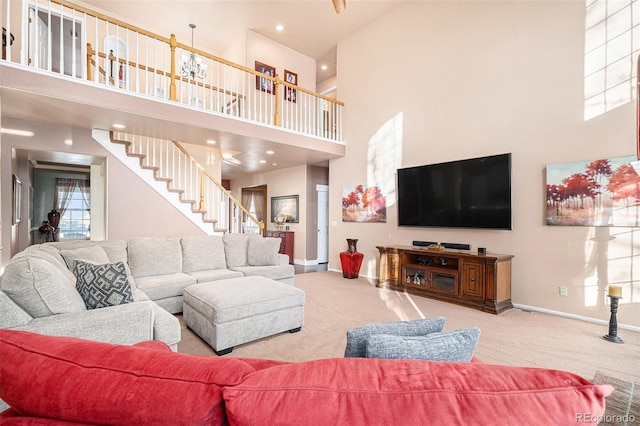 living room featuring light carpet and a towering ceiling