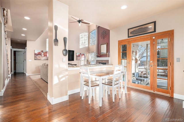 dining area with ceiling fan and dark hardwood / wood-style floors