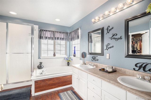 bathroom featuring shower with separate bathtub, vanity, and wood-type flooring