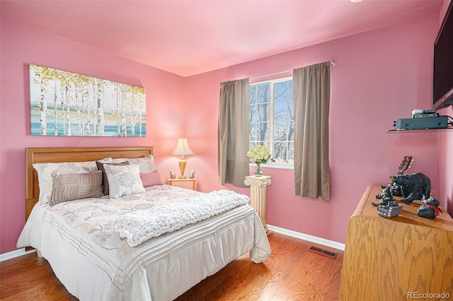 bedroom with wood-type flooring