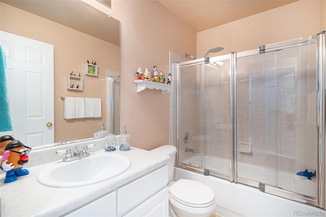 full bathroom featuring toilet, shower / bath combination with glass door, and vanity