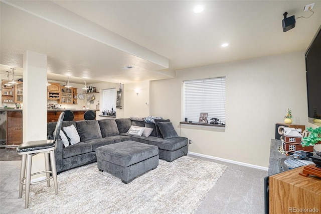 carpeted living room featuring indoor bar