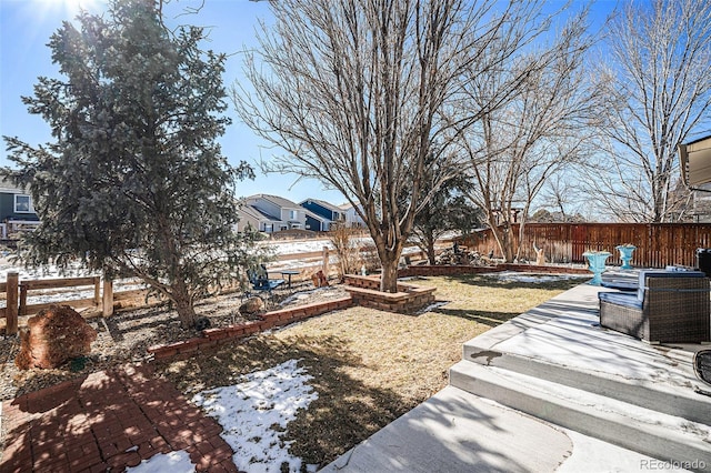 yard covered in snow with a patio