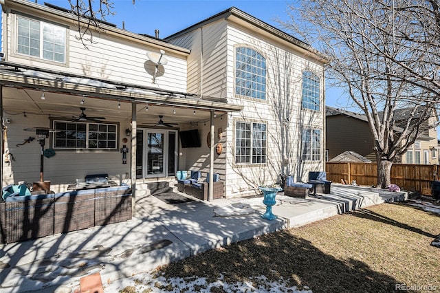 rear view of property with ceiling fan, a patio, and an outdoor living space