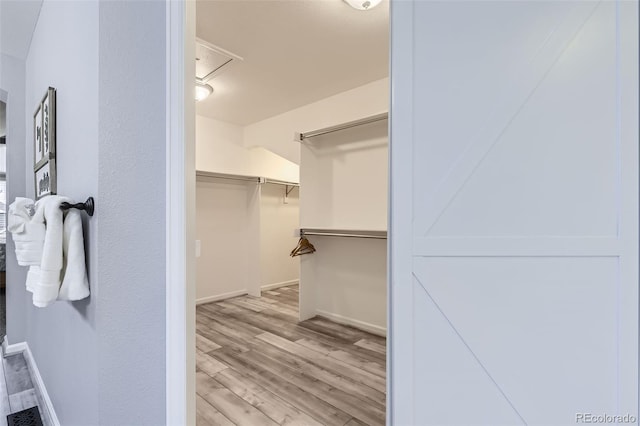 spacious closet with light wood finished floors