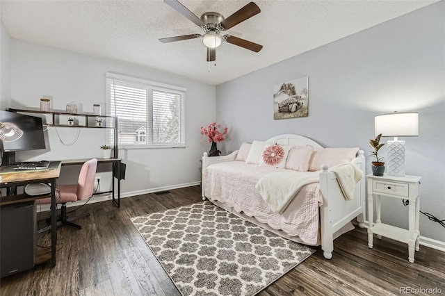 bedroom with baseboards, wood finished floors, a desk, ceiling fan, and a textured ceiling