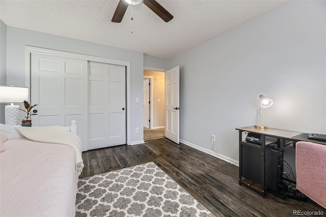 bedroom with wood finished floors, baseboards, a closet, and a ceiling fan